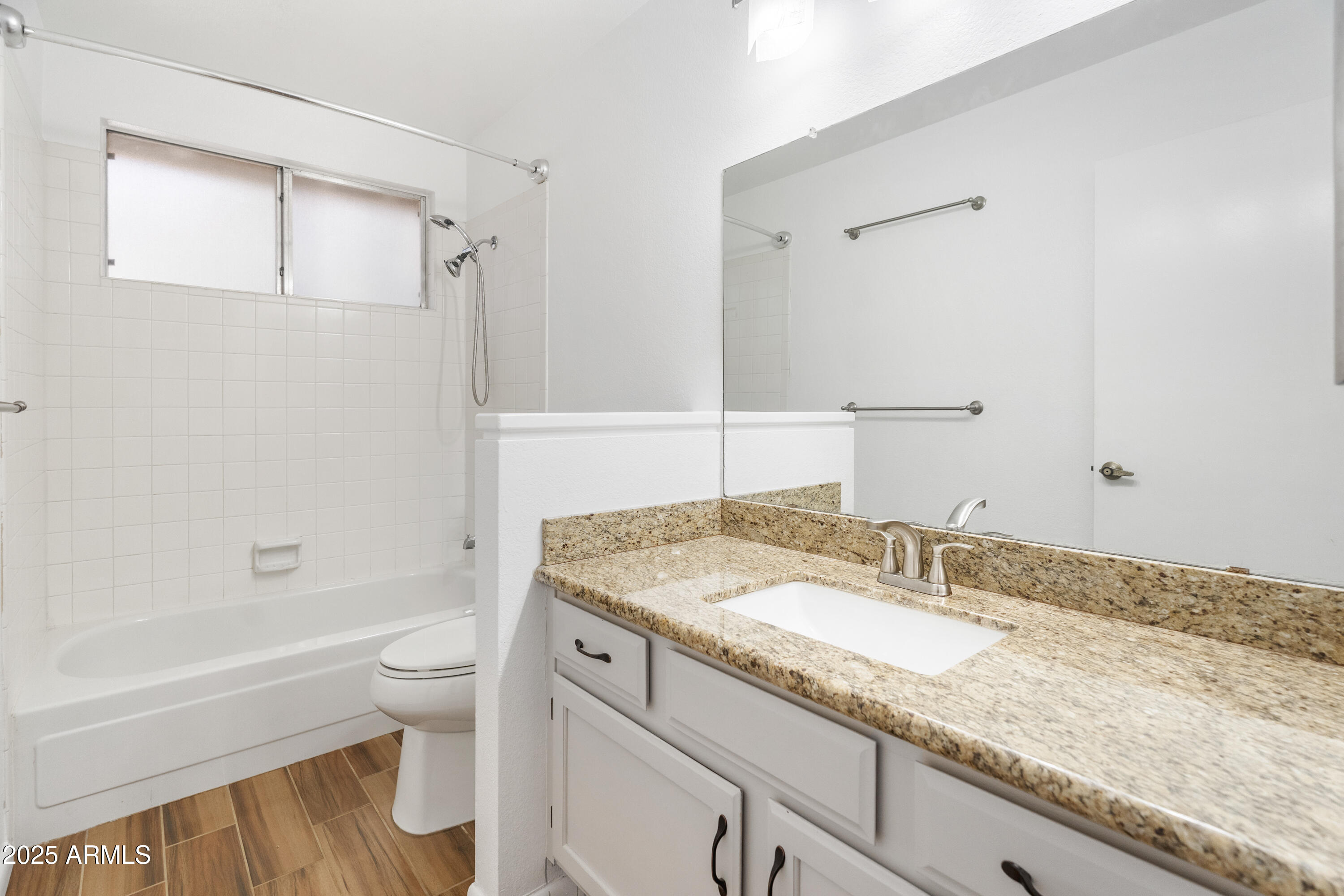 4652 East Piedmont Road Phoenix, AZ 85044 - Photo 17 of 30 a bathroom with a granite countertop sink a toilet and bathtub