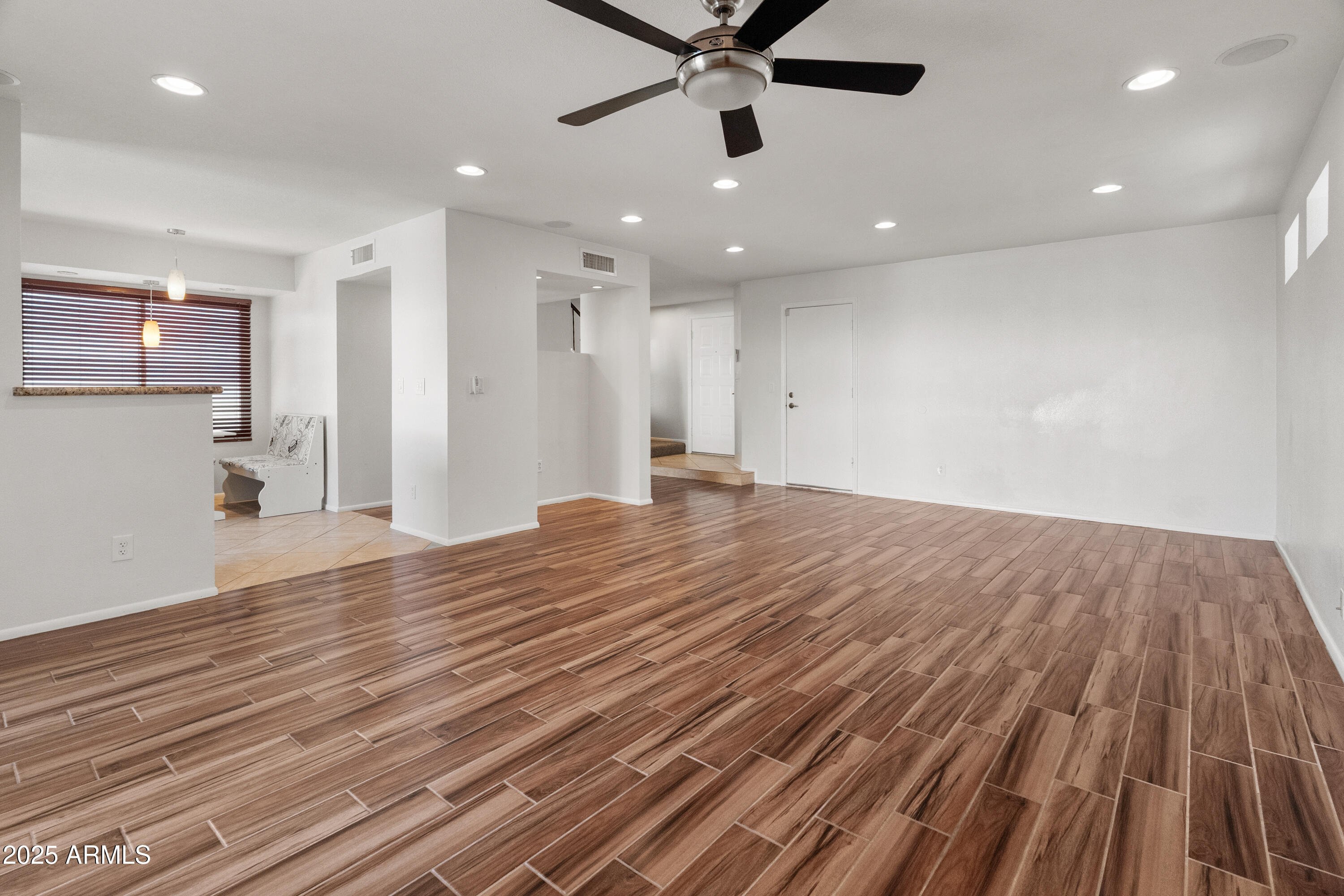 4652 East Piedmont Road Phoenix, AZ 85044 - Photo 8 of 30 a view of a livingroom with a ceiling fan and wooden floor