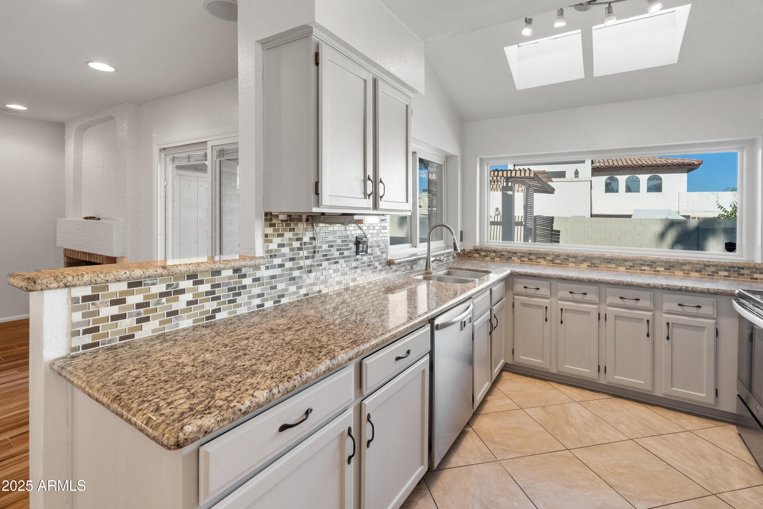 4652 East Piedmont Road Phoenix, AZ 85044 - Photo 9 of 30 a kitchen with sink cabinets and counter space