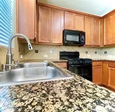 a kitchen with a stove a sink and a microwave