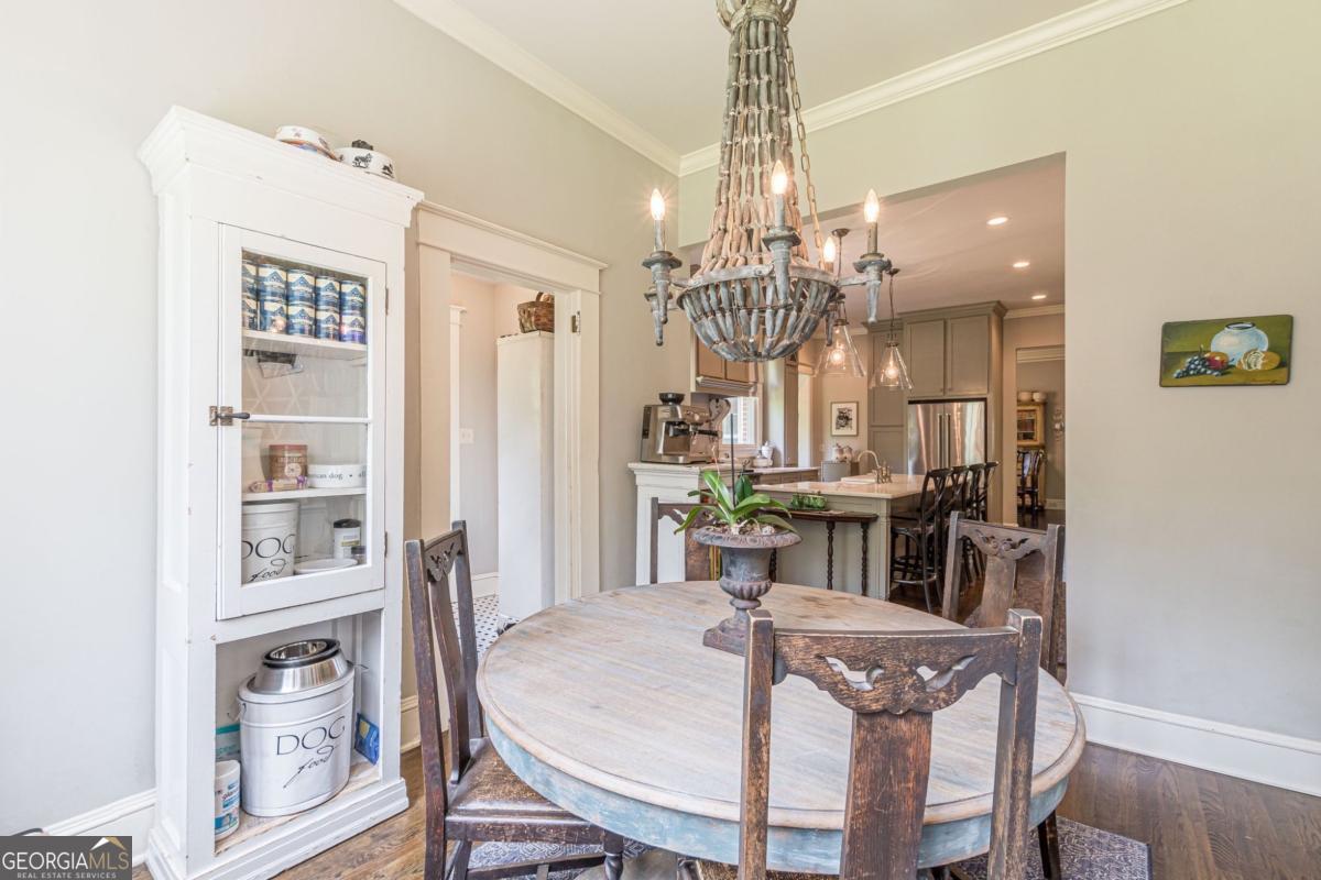 1878 Cambridge Avenue Atlanta, GA 30337 - Photo 24 of 84 a view of a dining room with furniture a chandelier and wooden floor