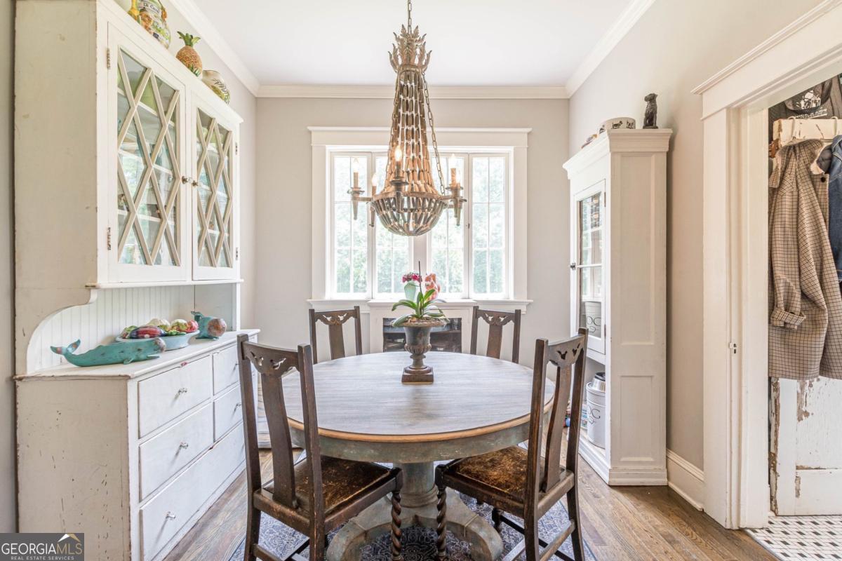 1878 Cambridge Avenue Atlanta, GA 30337 - Photo 28 of 84 a dining room with furniture a chandelier and wooden floor