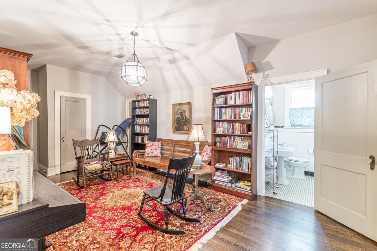 1878 Cambridge Avenue Atlanta, GA 30337 - Photo 58 of 84 a living room with furniture a rug and a bookshelf