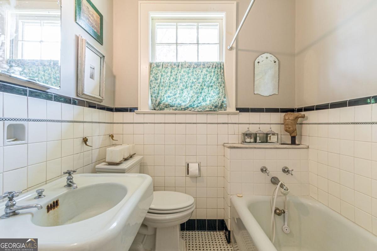 1878 Cambridge Avenue Atlanta, GA 30337 - Photo 70 of 84 a bathroom with a sink a toilet and a bathtub
