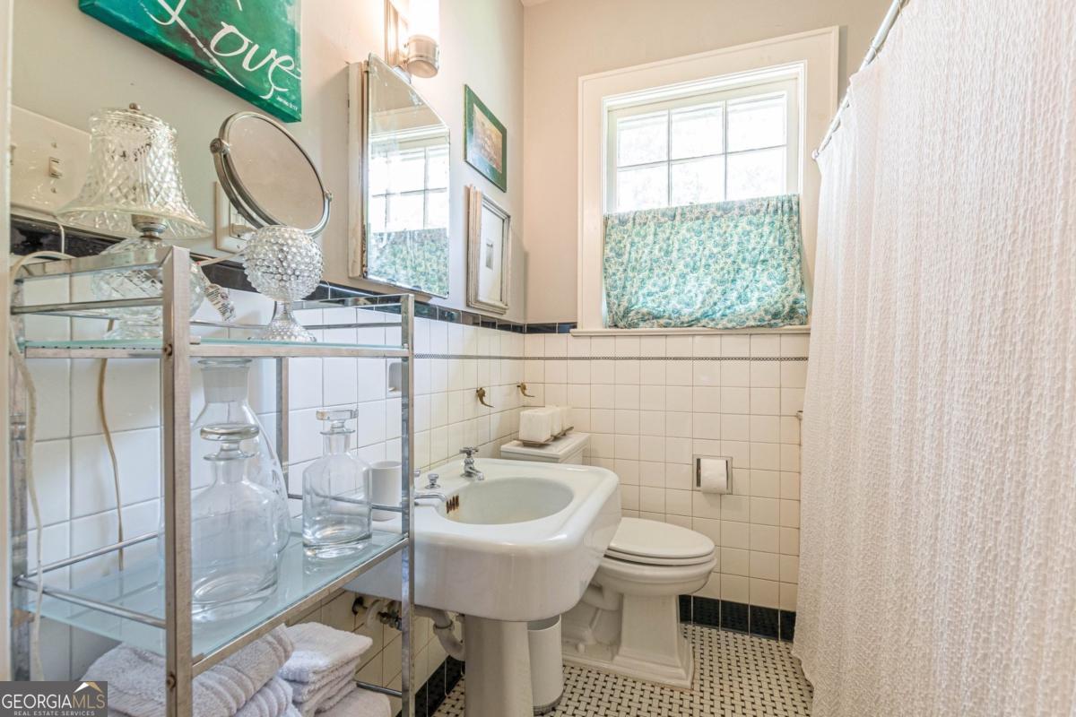 1878 Cambridge Avenue Atlanta, GA 30337 - Photo 74 of 84 a bathroom with a sink toilet and shower