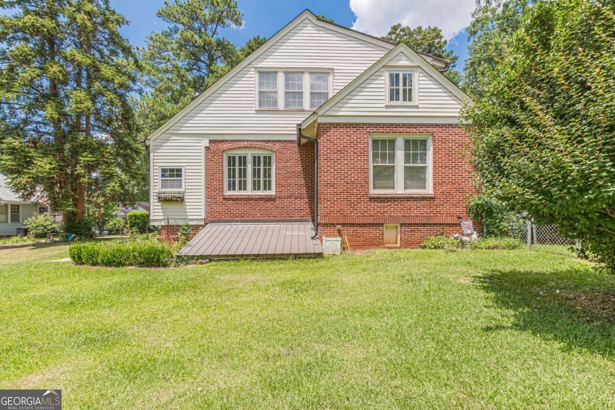 1878 Cambridge Avenue Atlanta, GA 30337 - Photo 83 of 84 a front view of a house with a yard and garage