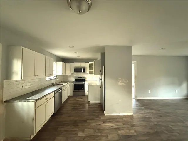 a kitchen with a sink and a refrigerator