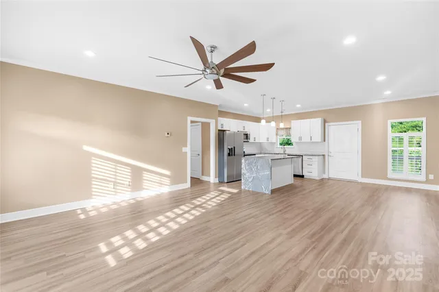 a view of a kitchen with a sink and a window