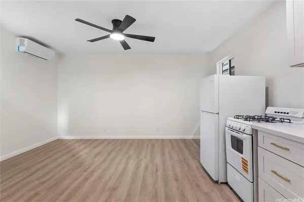 a view of a kitchen with stove and cabinets