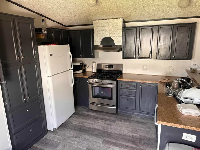 a kitchen with a refrigerator stove and sink