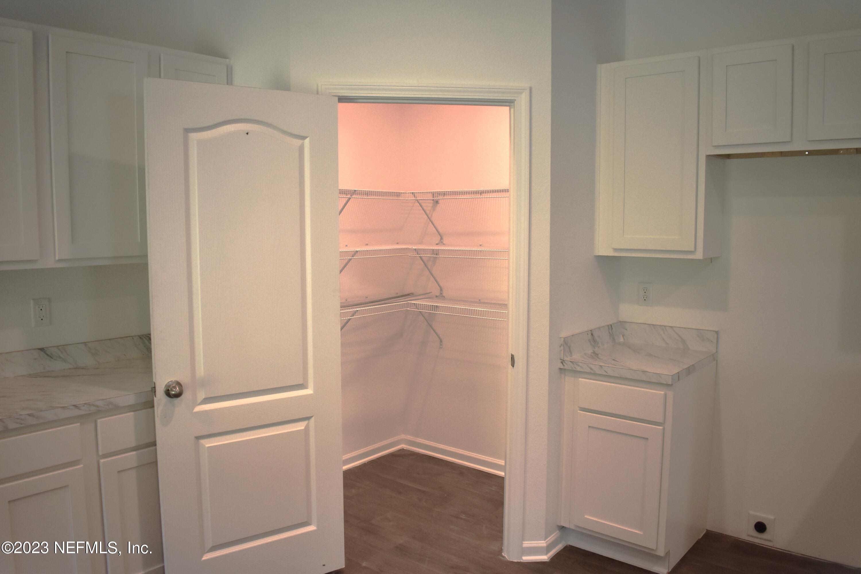 12817 Cacao Tree Trail Jacksonville, FL 32218 - Photo 12 of 41 a view of walk in closet with empty racks
