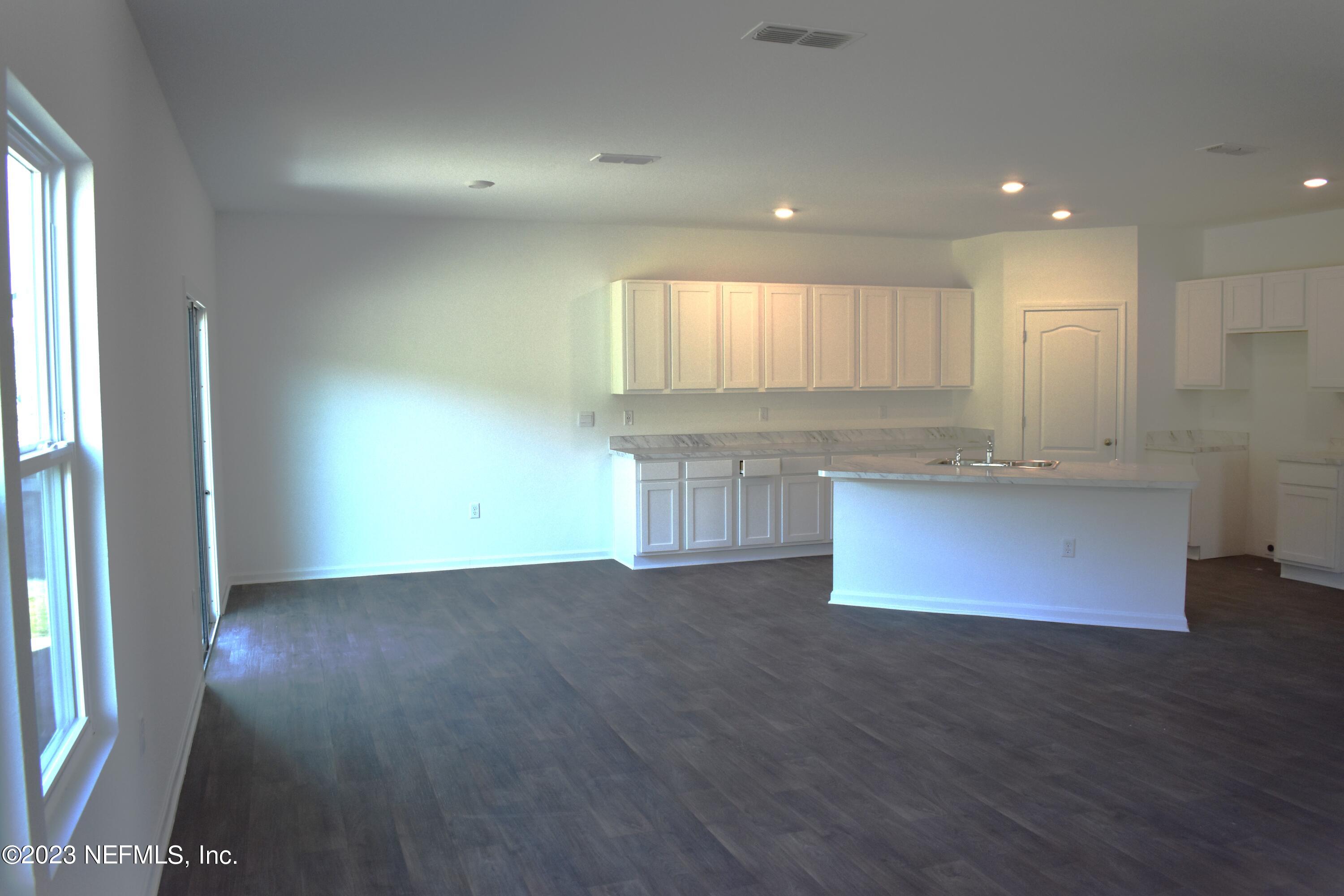 12817 Cacao Tree Trail Jacksonville, FL 32218 - Photo 13 of 41 a view of kitchen with granite countertop counter top space and wooden floor