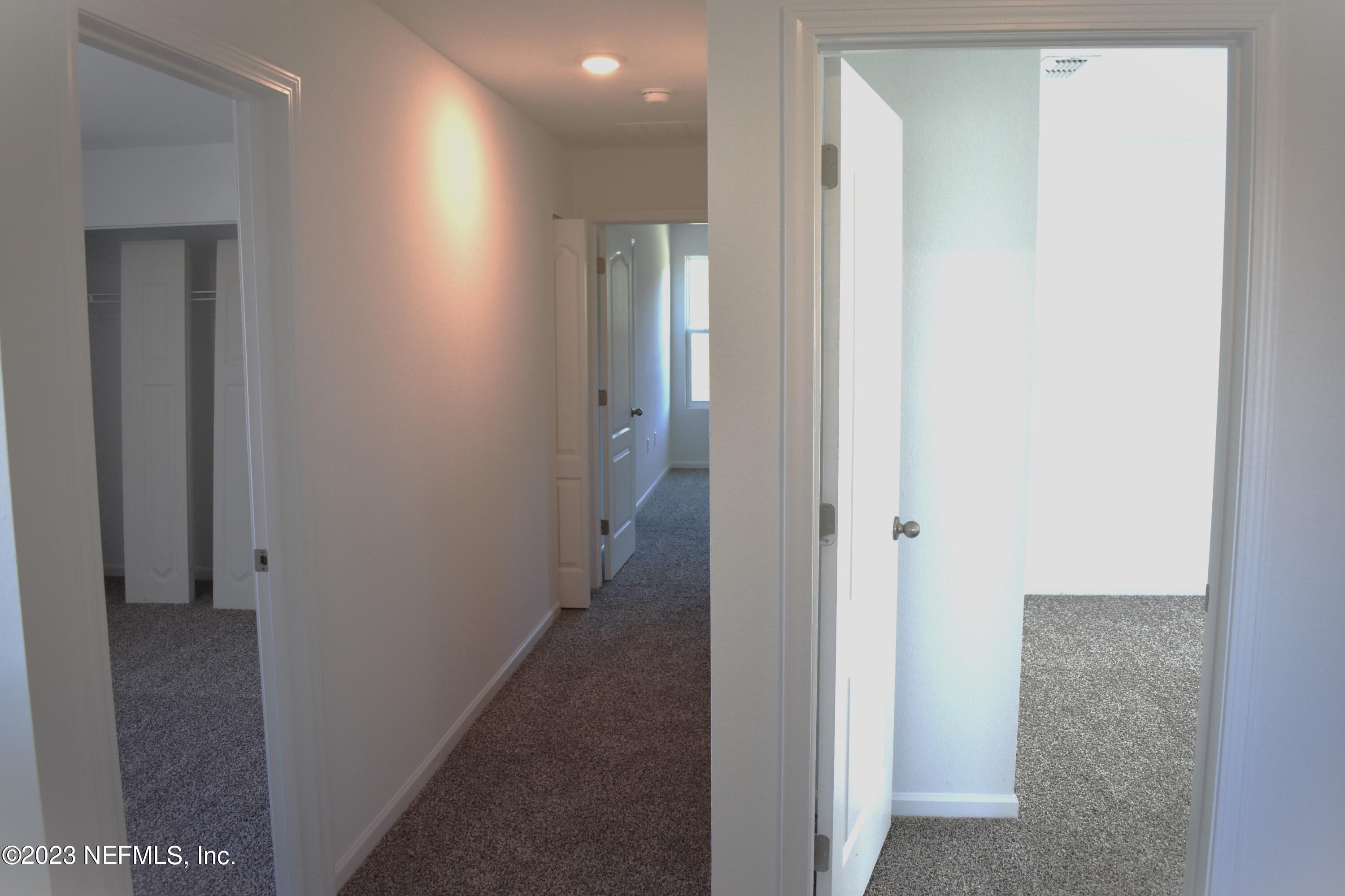 12817 Cacao Tree Trail Jacksonville, FL 32218 - Photo 17 of 41 a view of a hallway with a elevator