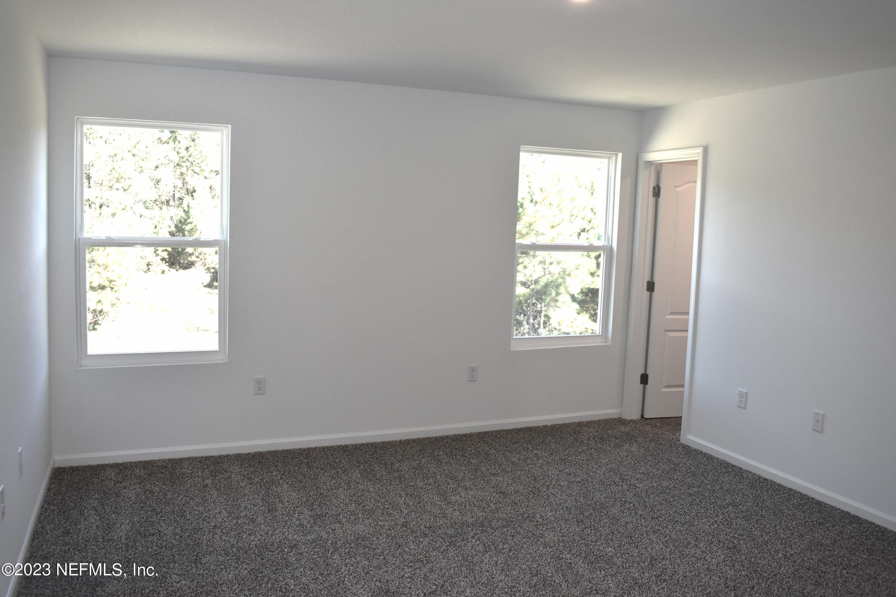 12817 Cacao Tree Trail Jacksonville, FL 32218 - Photo 18 of 41 an empty room with a window