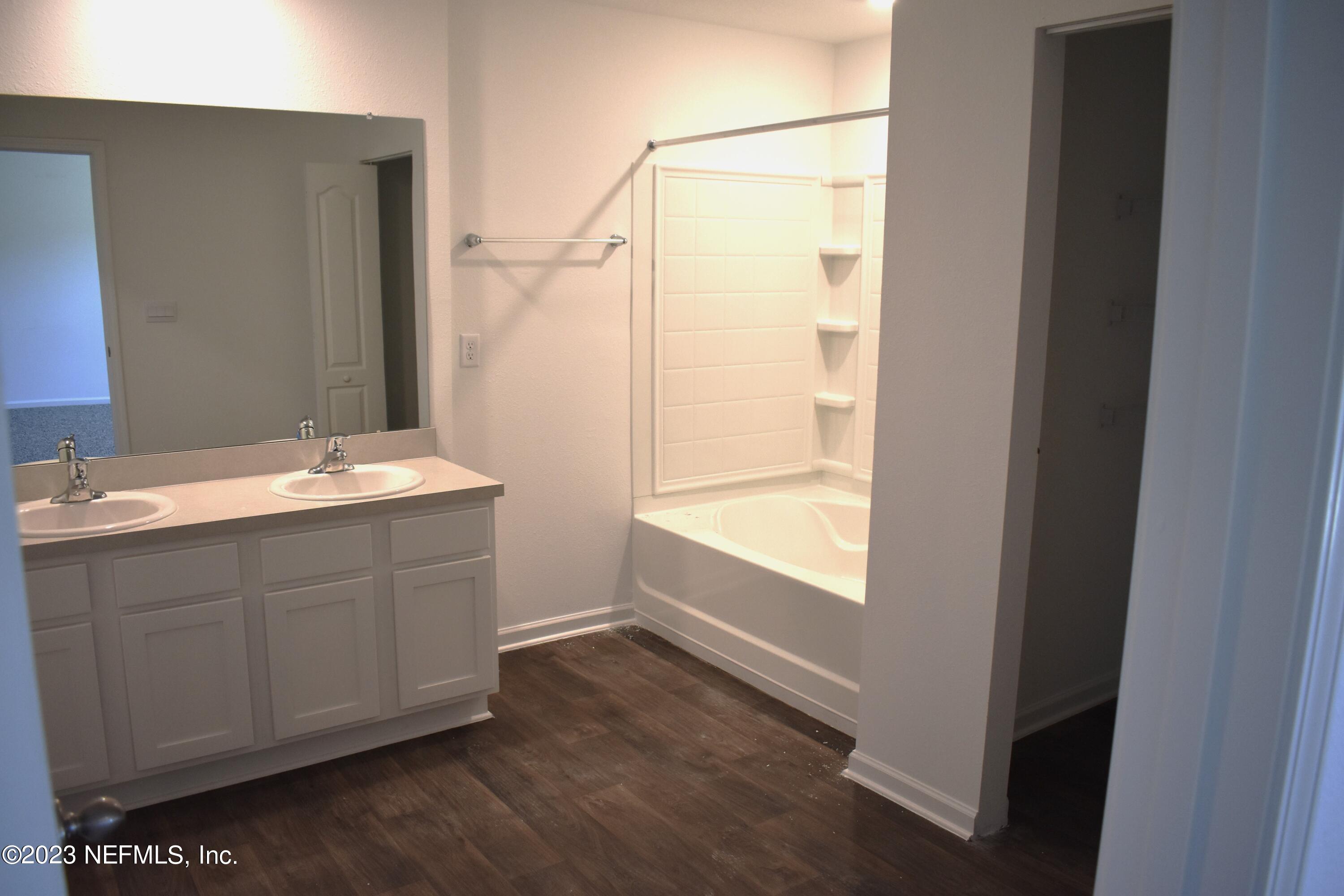 12817 Cacao Tree Trail Jacksonville, FL 32218 - Photo 20 of 41 a bathroom with a sink and a mirror