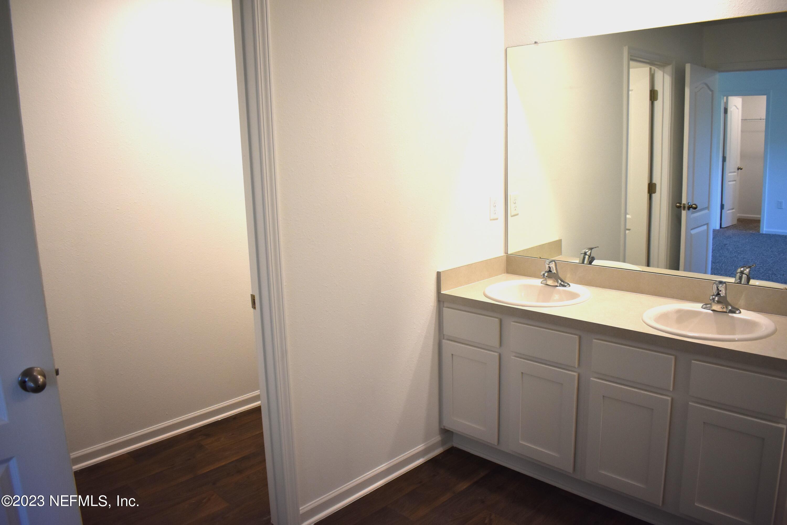 12817 Cacao Tree Trail Jacksonville, FL 32218 - Photo 22 of 41 a bathroom with a sink and a mirror