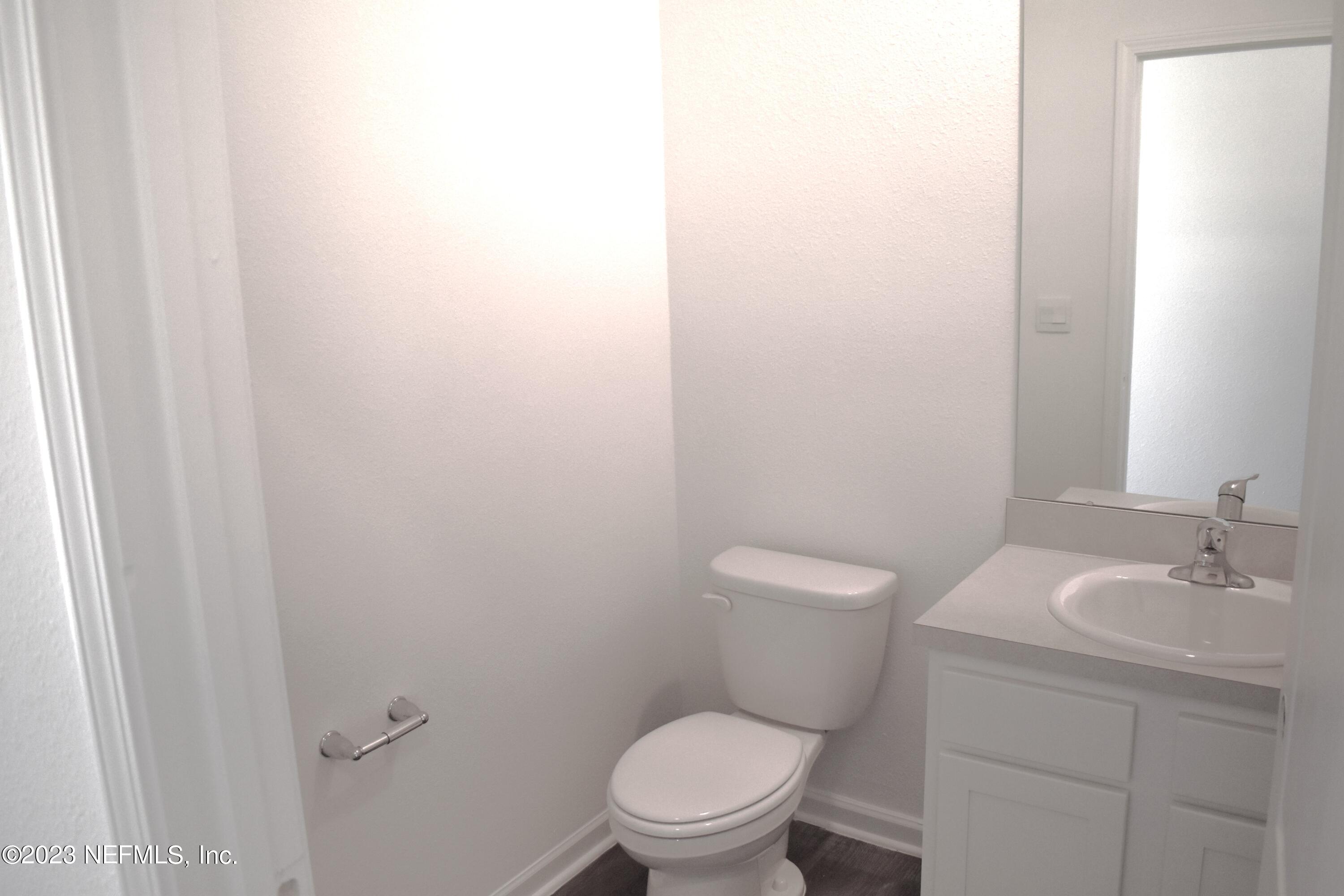 12817 Cacao Tree Trail Jacksonville, FL 32218 - Photo 6 of 41 a bathroom with a toilet a sink and mirror