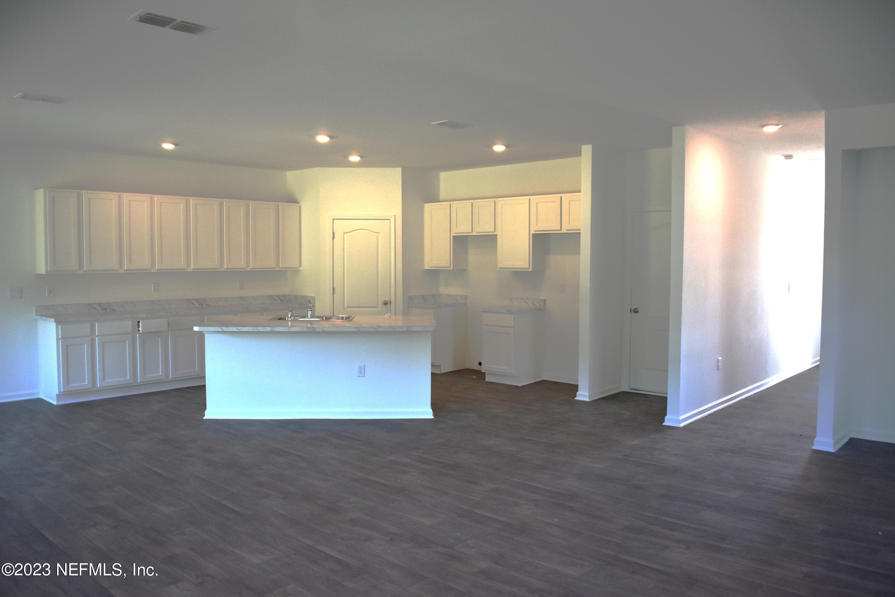 12817 Cacao Tree Trail Jacksonville, FL 32218 - Photo 9 of 41 a view of kitchen with granite countertop cabinets and refrigerator