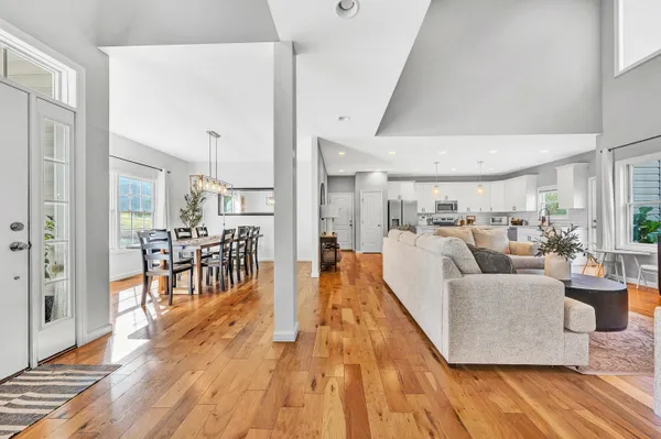 a living room with furniture and a wooden floor