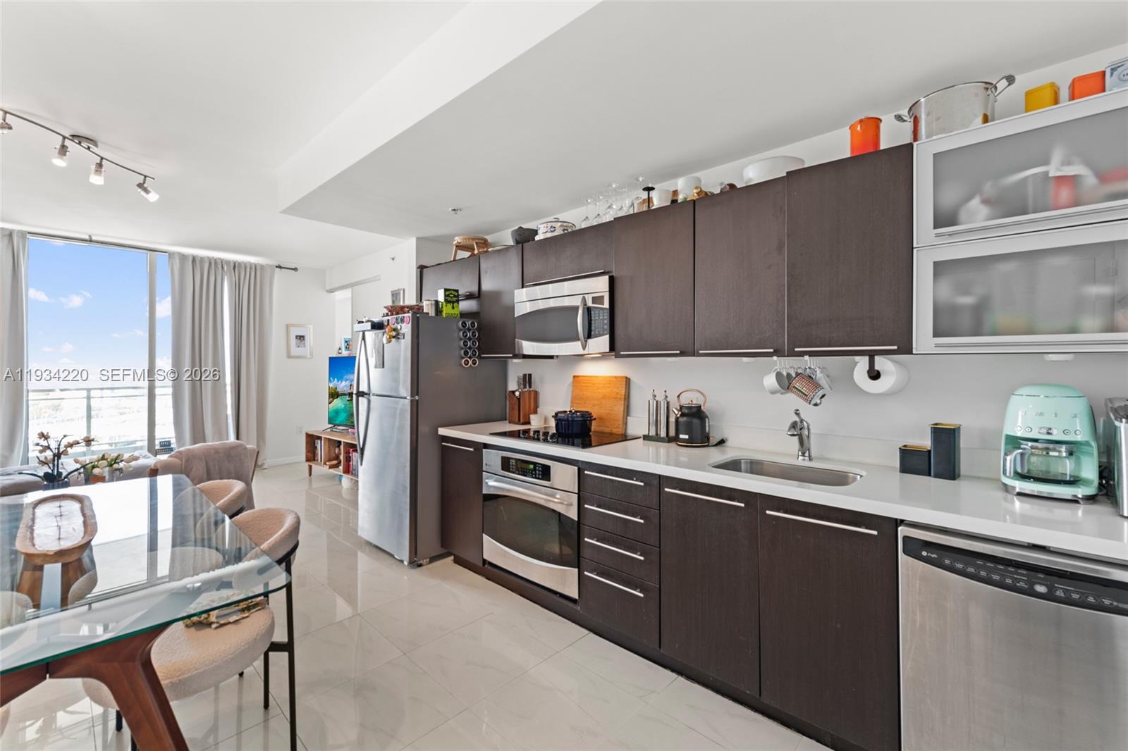 90 Southwest 3rd Street, Unit 2109 Miami, FL 33130 - Photo 13 of 31 a kitchen with stainless steel appliances a sink cabinets and wooden floor