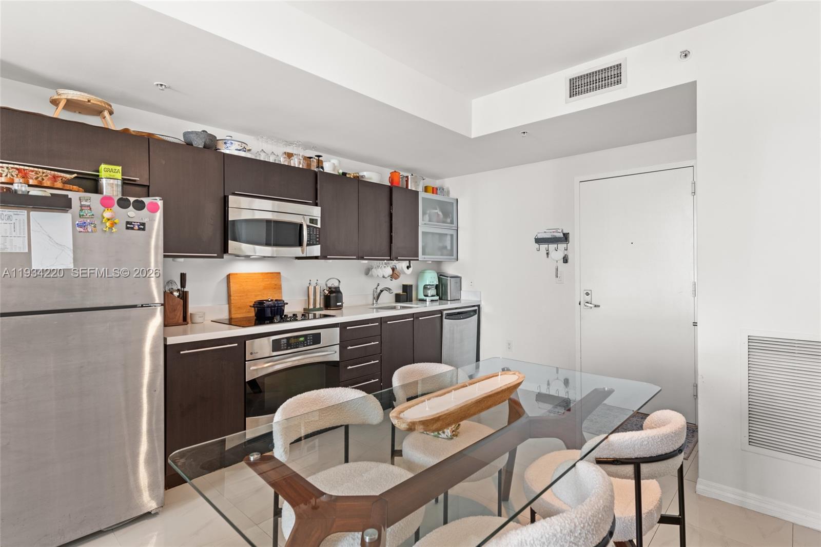 90 Southwest 3rd Street, Unit 2109 Miami, FL 33130 - Photo 14 of 31 a kitchen with stainless steel appliances a refrigerator and a stove top oven
