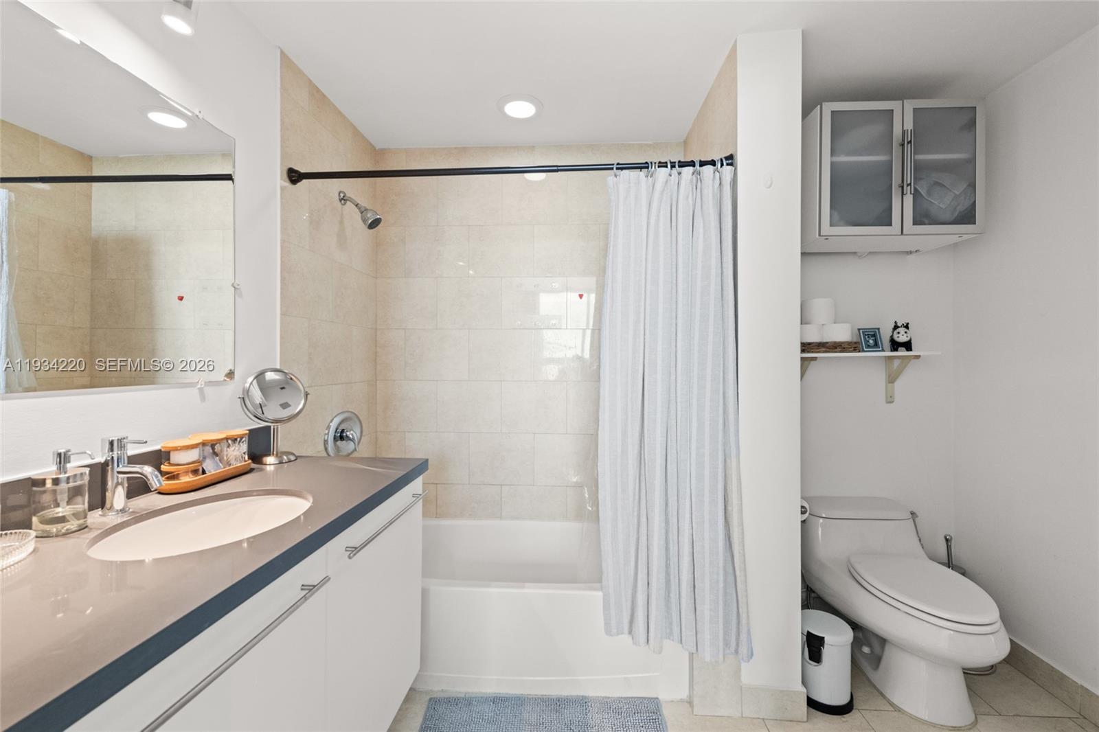 90 Southwest 3rd Street, Unit 2109 Miami, FL 33130 - Photo 20 of 31 a bathroom with a granite countertop sink toilet and shower
