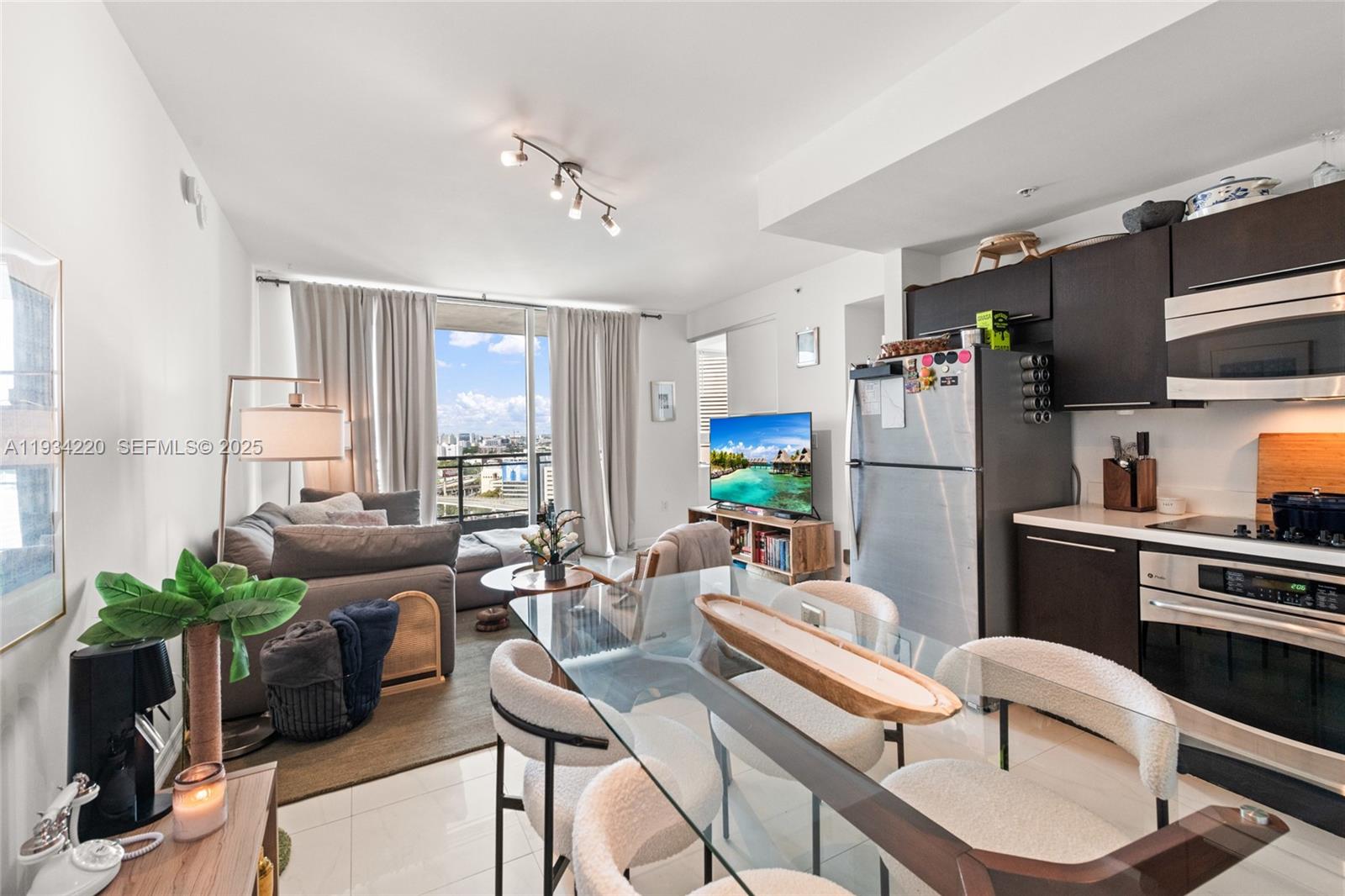 90 Southwest 3rd Street, Unit 2109 Miami, FL 33130 - Photo 10 of 29 a living room with furniture and a window