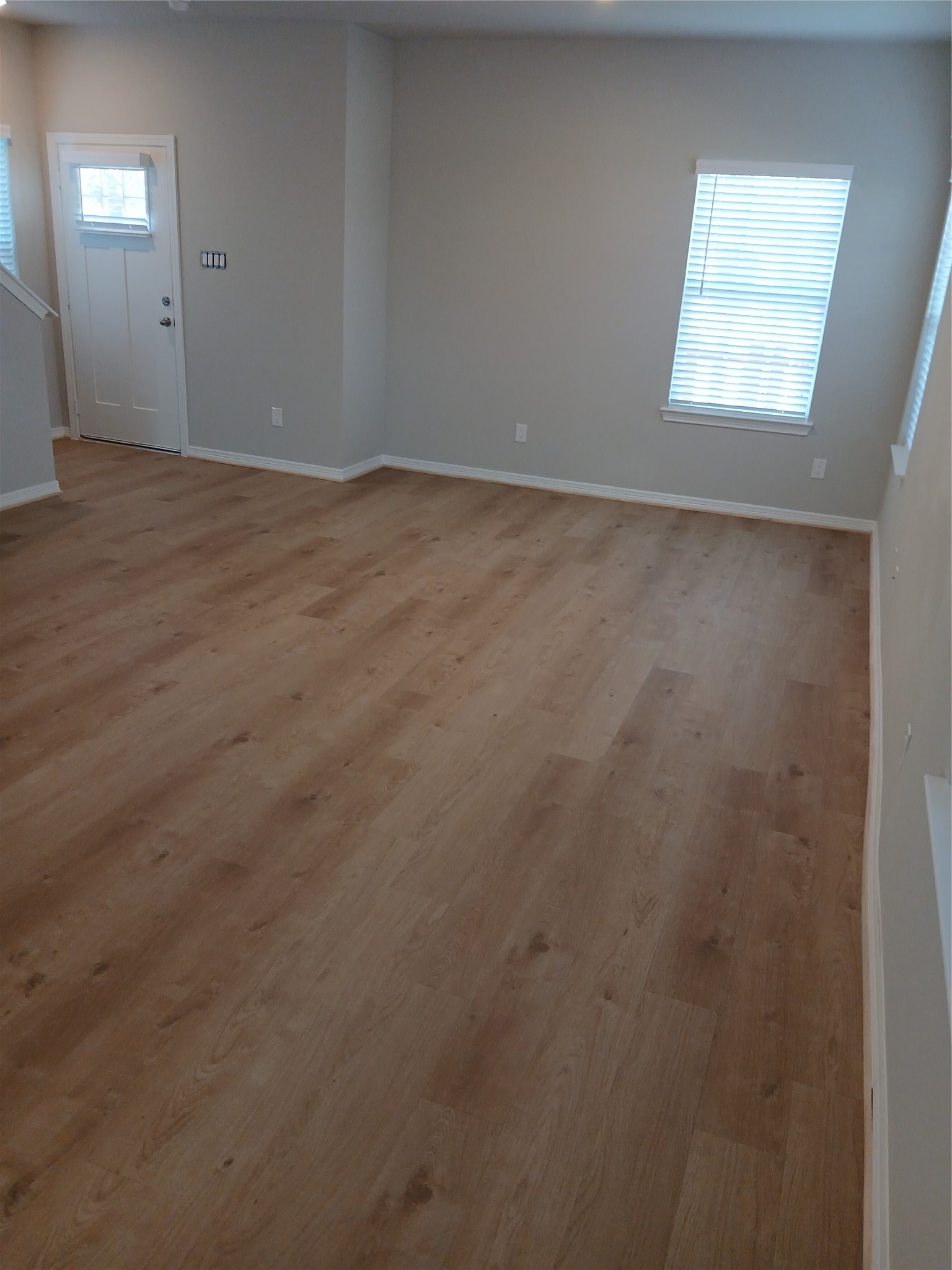 6403 Paris Street Houston, TX 77021 - Photo 5 of 16 an empty room with wooden floor and windows