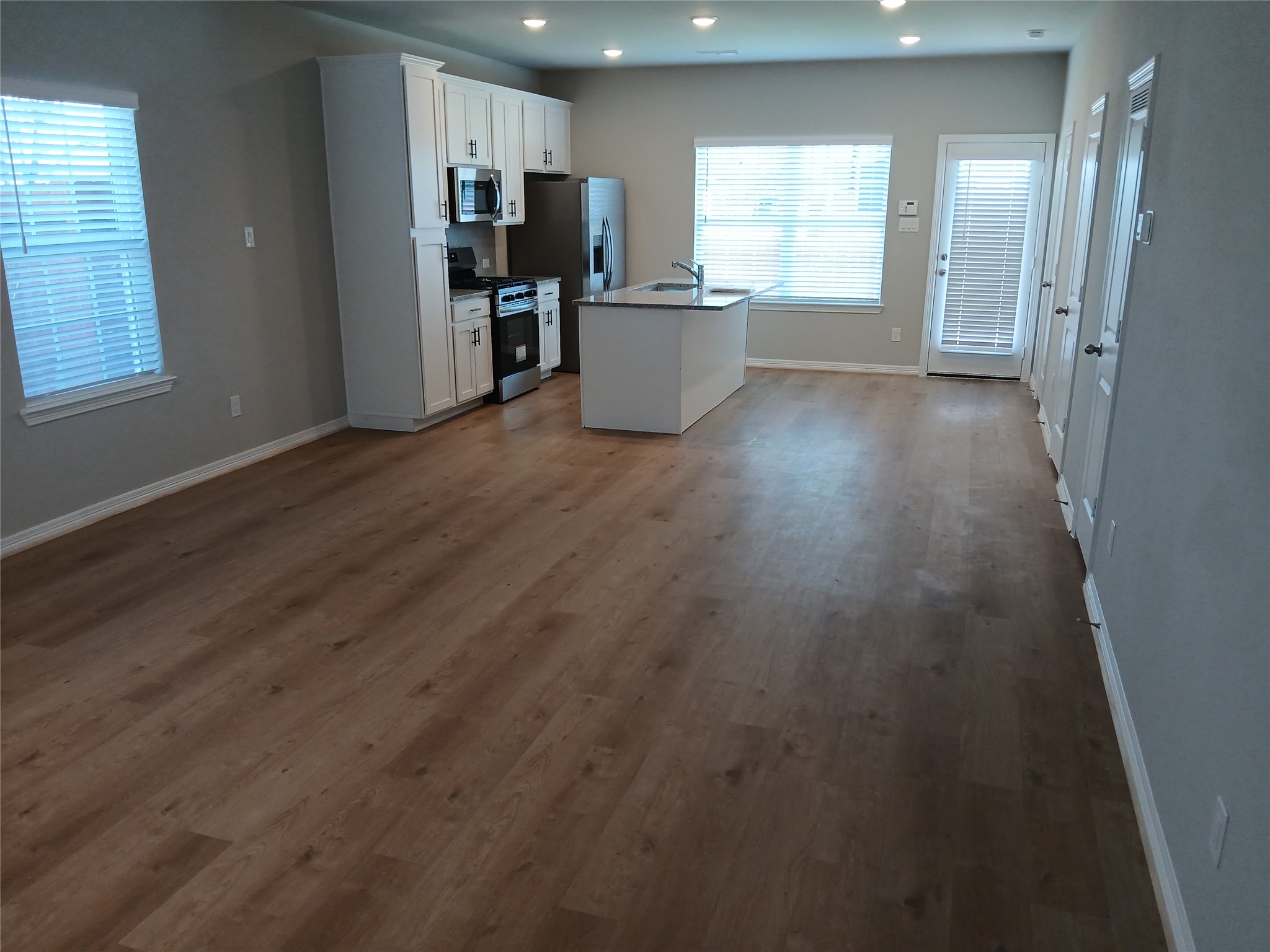 6403 Paris Street Houston, TX 77021 - Photo 7 of 16 an empty room with wooden floor and windows
