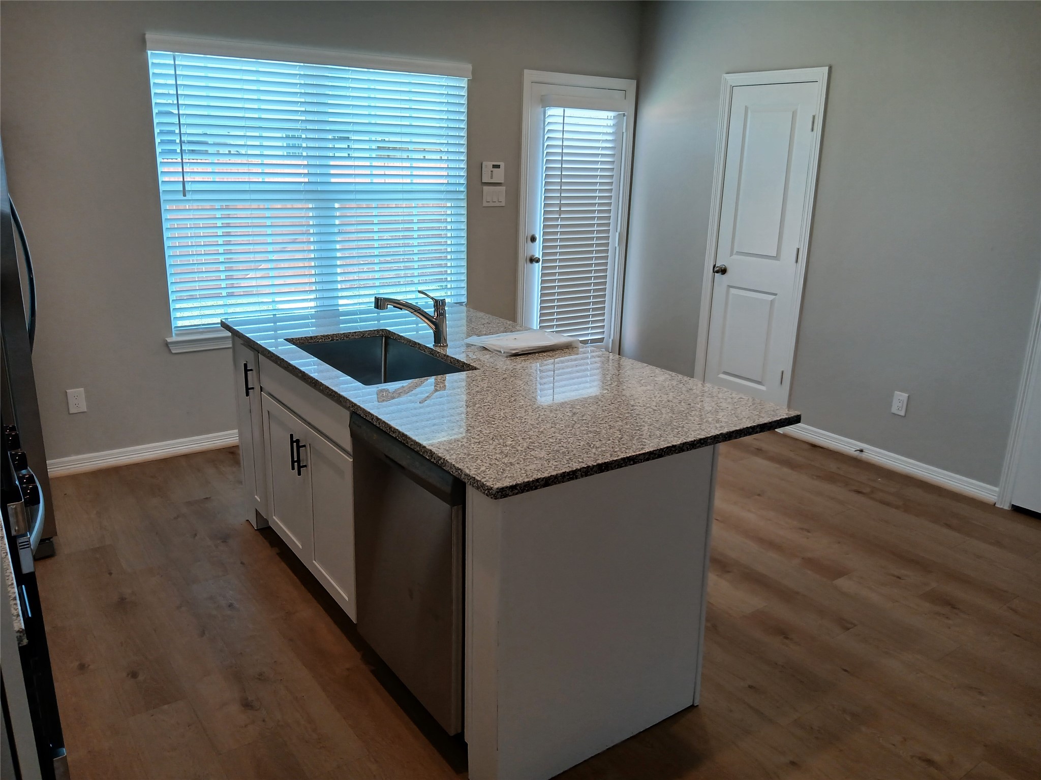6403 Paris Street Houston, TX 77021 - Photo 9 of 16 an empty room with wooden floor and windows