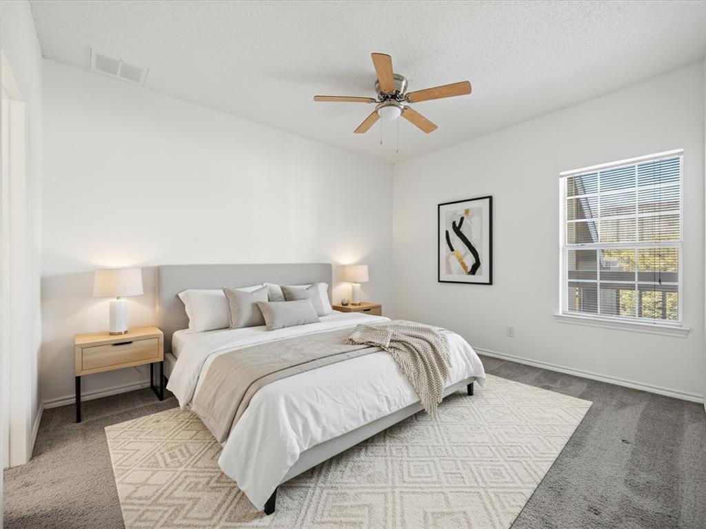 5310 Keller Springs Road, Unit 332 Dallas, TX 75248 - Photo 7 of 39 Carpeted bedroom with a ceiling fan and a textured ceiling