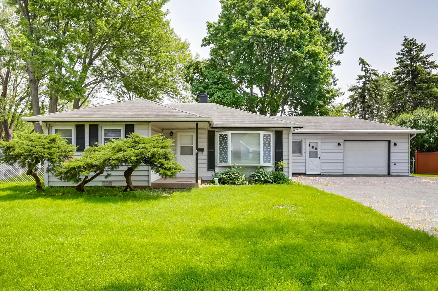 a view of a house with a yard and sitting area