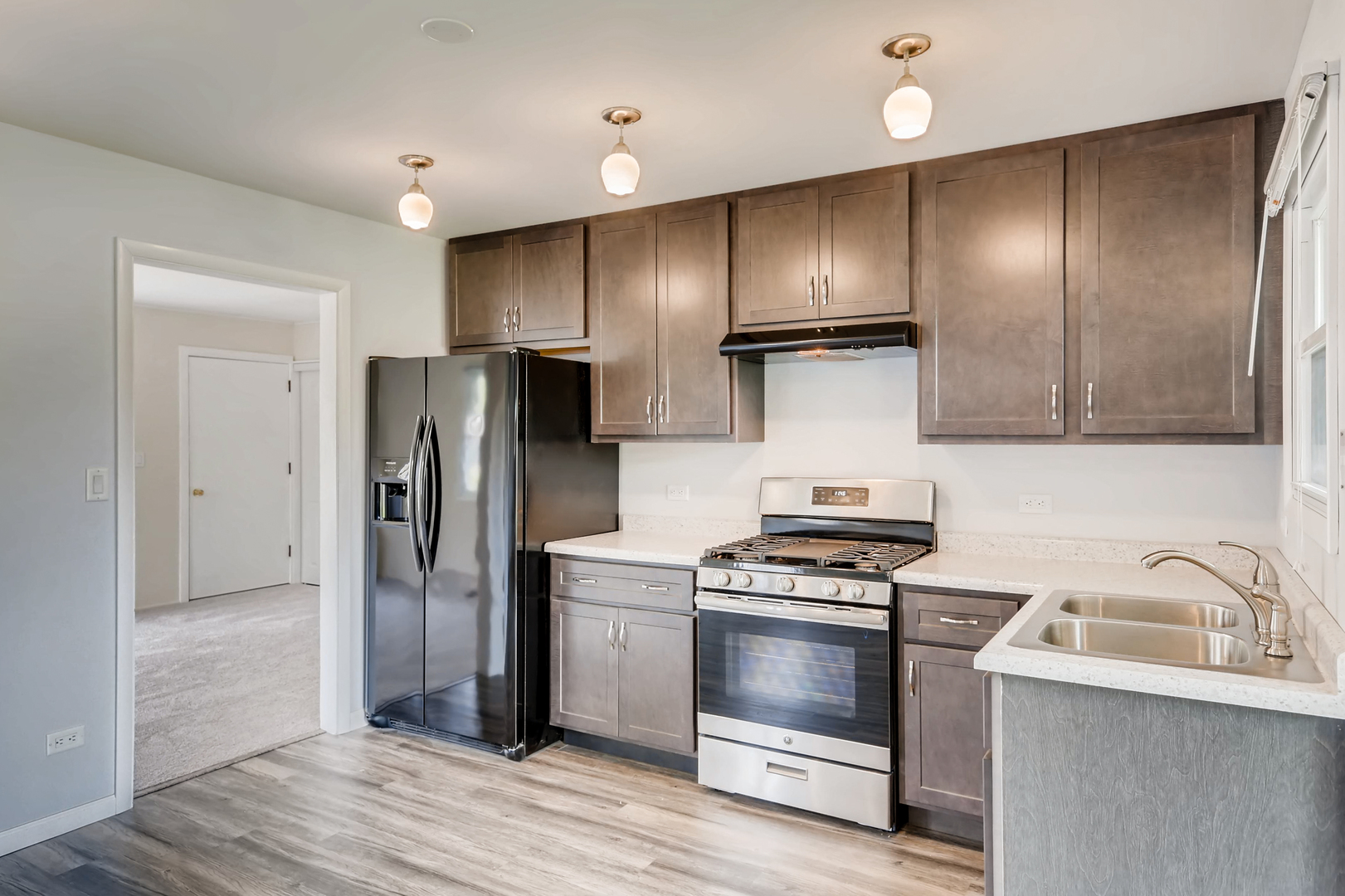 3104 Dove Court Rolling Meadows, IL 60008 - Photo 5 of 12 a kitchen with stainless steel appliances wooden cabinets and a stove top oven