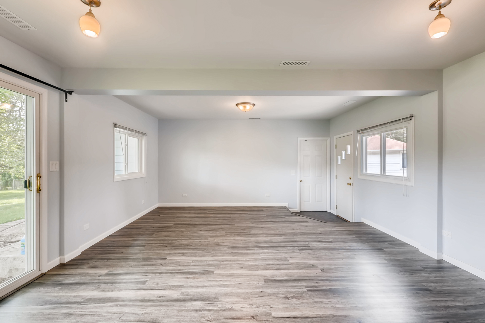 3104 Dove Court Rolling Meadows, IL 60008 - Photo 7 of 12 an empty room with wooden floor and windows