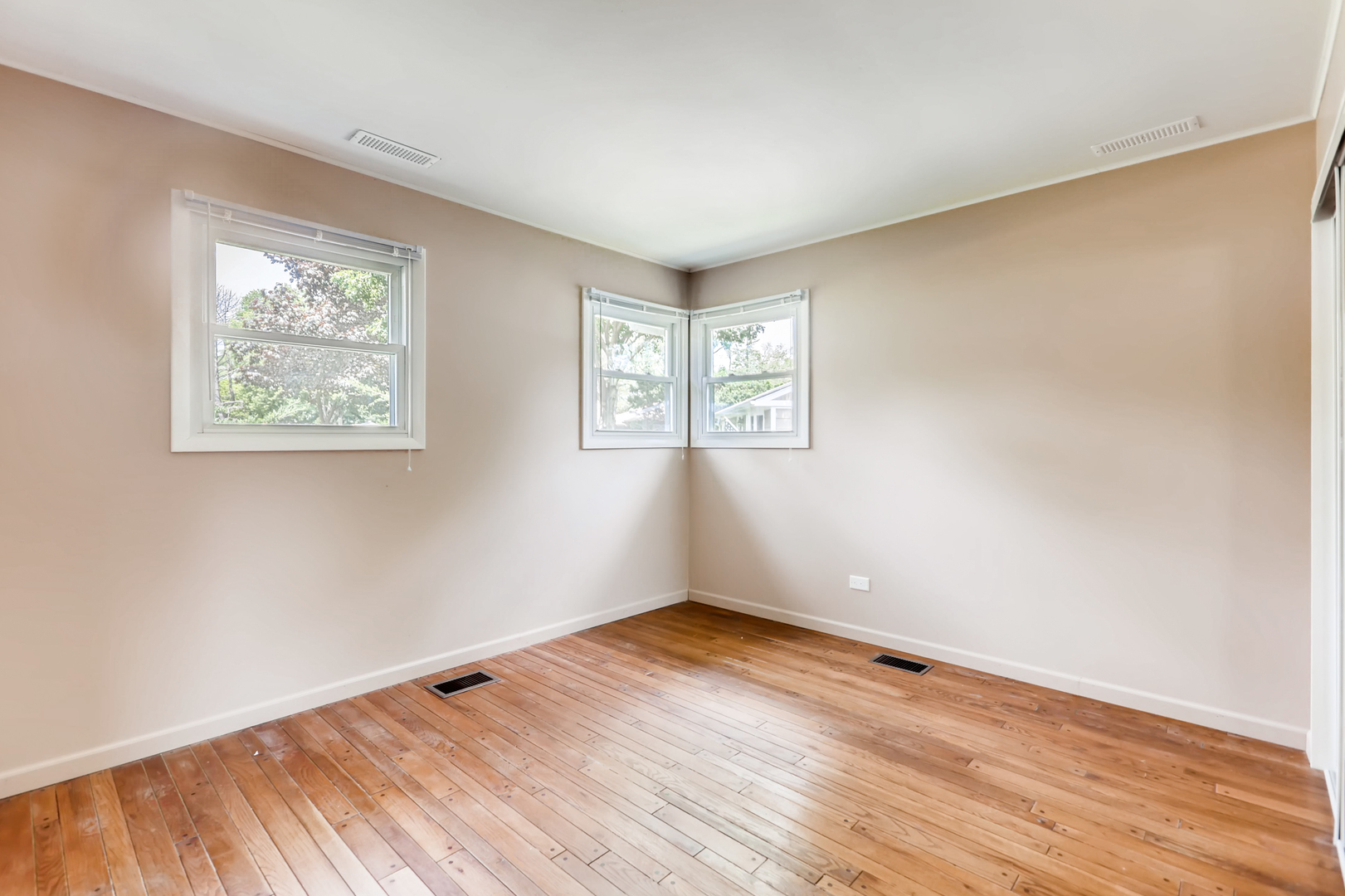 3104 Dove Court Rolling Meadows, IL 60008 - Photo 10 of 12 an empty room with wooden floor and windows