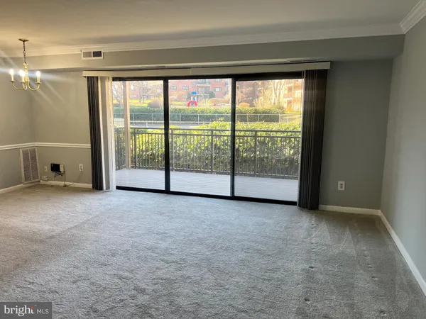 a view of an empty room with a sliding door