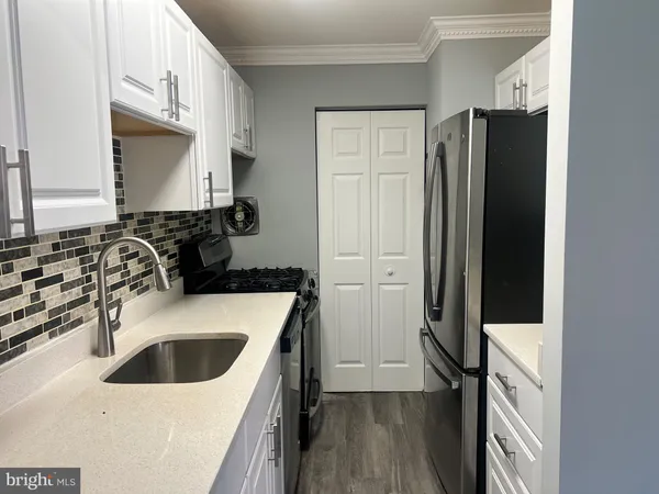 a kitchen with a sink stove and refrigerator