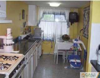 5508 Hana Road Edison, NJ 08817 - Photo 2 of 6 a kitchen with a sink and a stove top oven