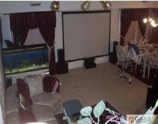 5508 Hana Road Edison, NJ 08817 - Photo 6 of 6 a living room with furniture and a flat screen tv