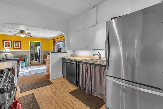 a kitchen with stainless steel appliances granite countertop a refrigerator and a stove