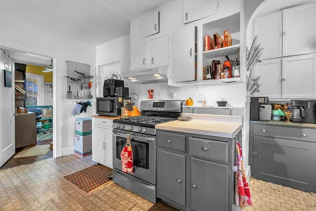 a kitchen with a stove and cabinets