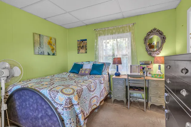 a bedroom with a bed and a table