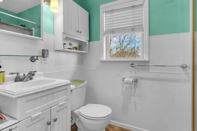 a bathroom with a sink a toilet and a shower curtain