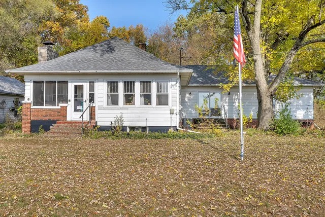 a house that has a tree in front of it
