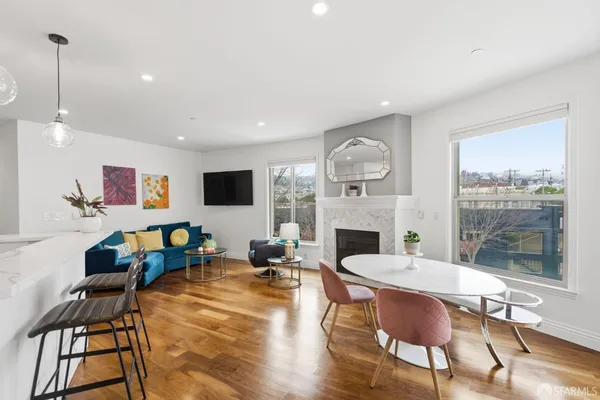 a living room with furniture a fireplace and a flat screen tv