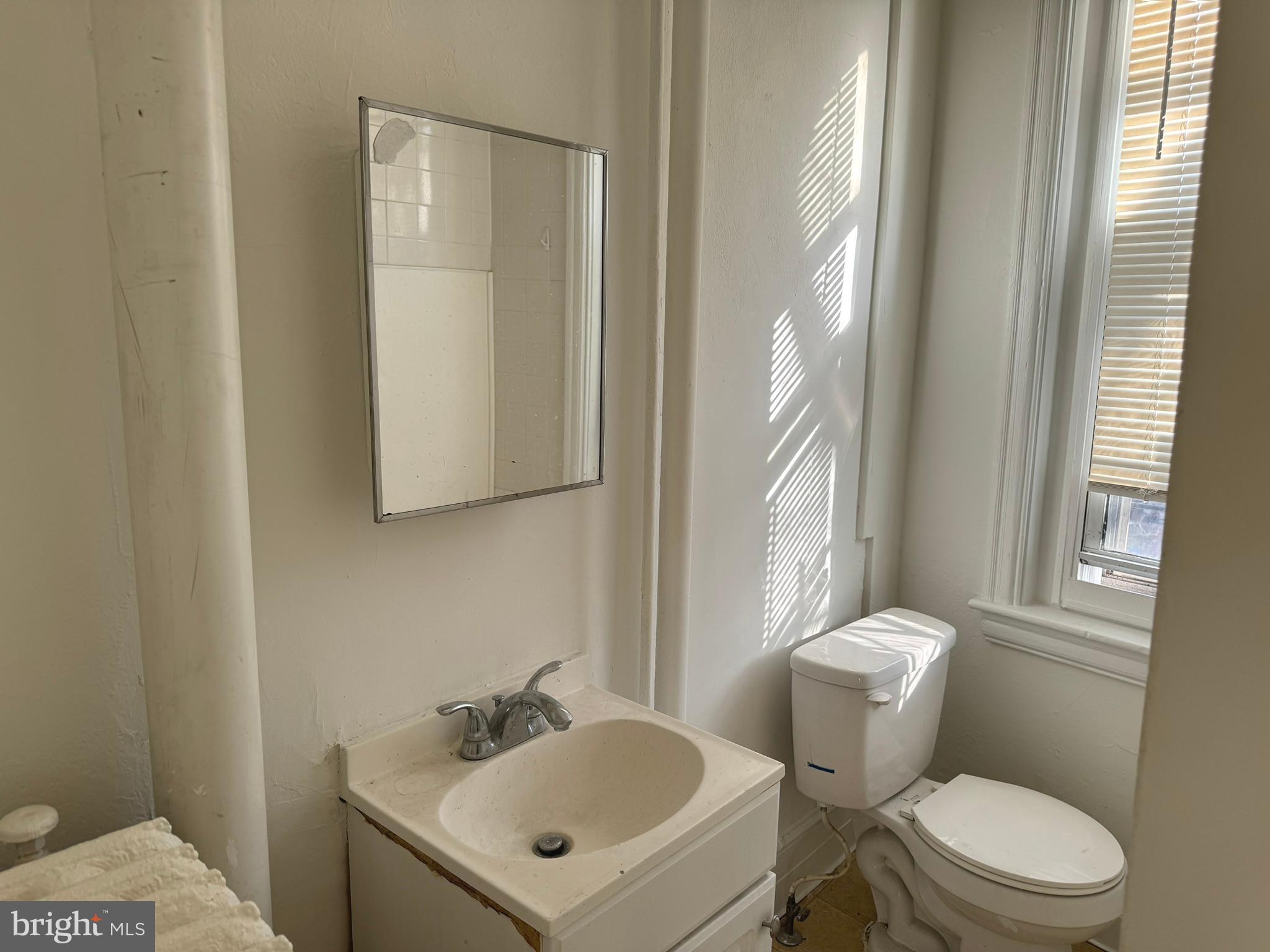 1 North Main Street, Unit 2F Ambler, PA 19002 - Photo 13 of 23 a white toilet sitting next to a bathroom sink