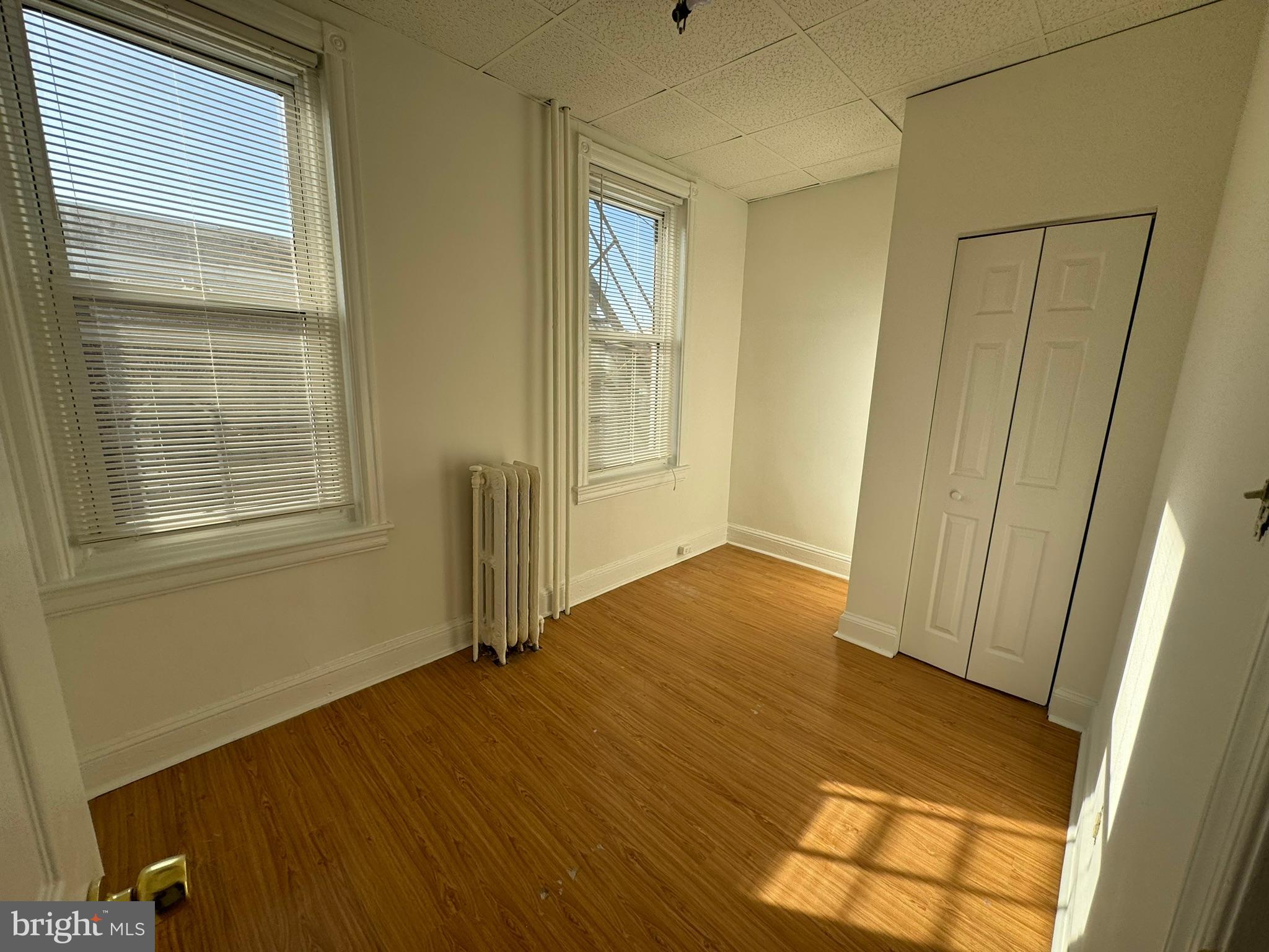 1 North Main Street, Unit 2F Ambler, PA 19002 - Photo 16 of 23 a view of an empty room with wooden floor and a window