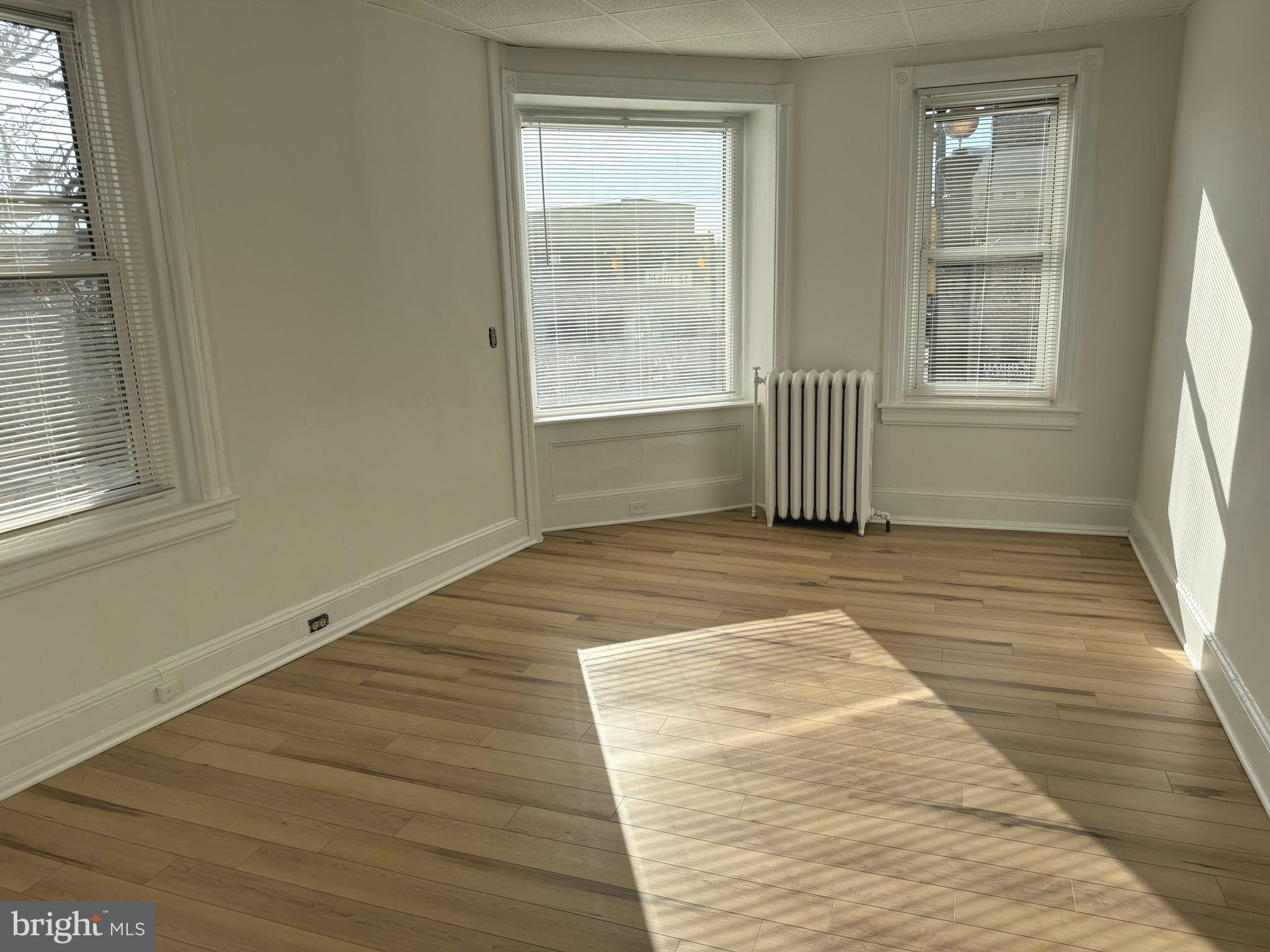 1 North Main Street, Unit 2F Ambler, PA 19002 - Photo 5 of 23 a view of empty room with wooden floor and fan