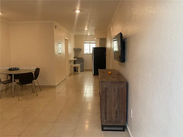 a view of a kitchen with furniture and a flat screen tv