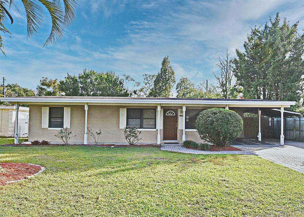 2148 Ridge Drive Winter Park, FL 32792 - Photo 1 of 33 a view of a house with backyard sitting area and garden